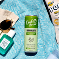Cans of Owl's Brew Rum Mojito and Neutrogena products on a blue patterned surface.