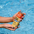 Can of Sun Tea Vodka being held over water